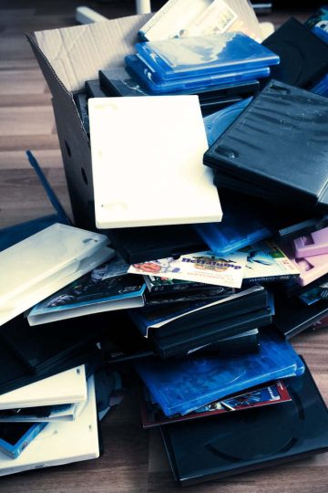 A pile of DVD covers on the floor