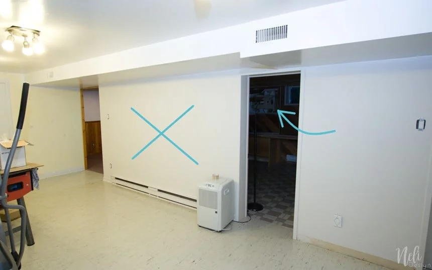 An X indicates the wall that will be demolished and an arrow shows the electrical panel
