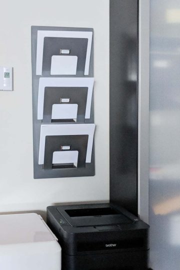 Simple Printer paper storage to help you keep your sanity. This idea will organize your printer area and desk. This simple magazine holder is a great solution. It also comes with a free printable for the labels #deskorganization #printables # freebie #paperstorage