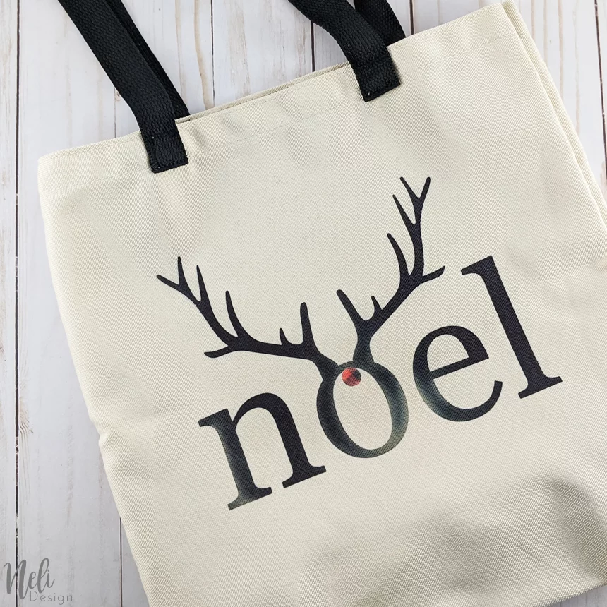 Bag with the writing Noel in black with antlers.