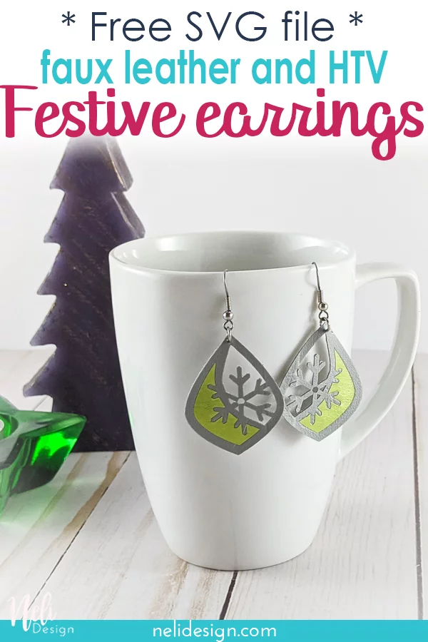 faux leather and green vinyl earrings hung on a mug with a fir tree and a star candle written free SVG file DIY festive earrings in Faux leather and HTV.
