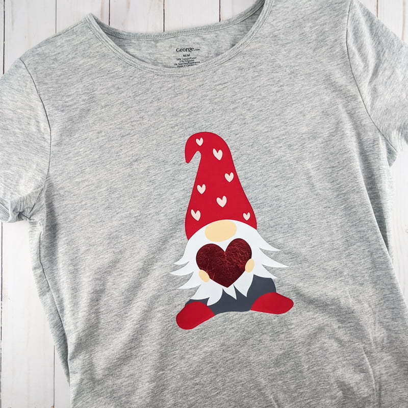 layered Iron-on vinyl of a Valentine gnome on a gray t-shirt