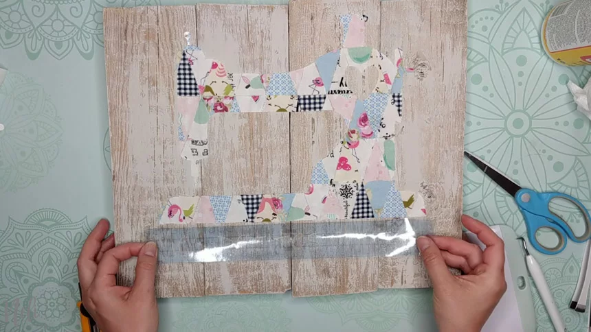 Apply the stencil with the transfer paper on the frame with fabric scraps.