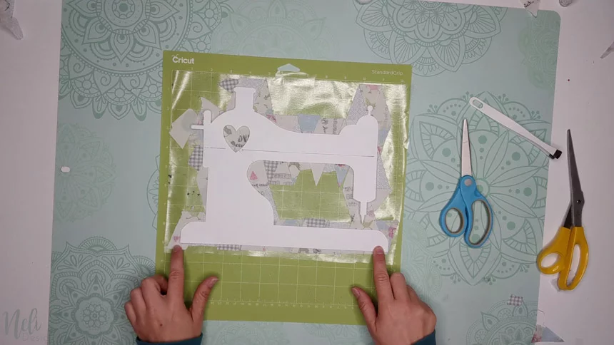 Transfer to the Cricut mat to make a frame with fabric scraps. 