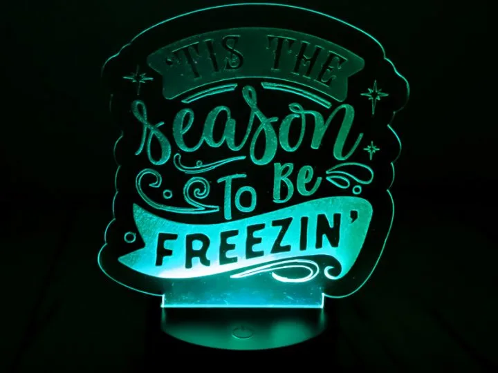 An engraved led night light written it's the season to be freezing
